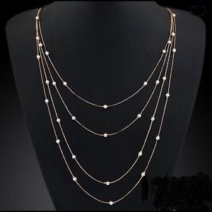 Four strand layered gold and pearl necklace.